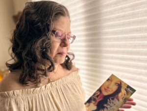 Deidre holding a photo of her organ donor Kameron
